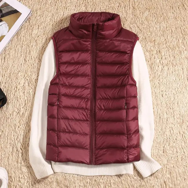 Ultra-light, warm women's down vest, perfect lightweight outerwear for chilly days. A cozy, packable puffer vest.