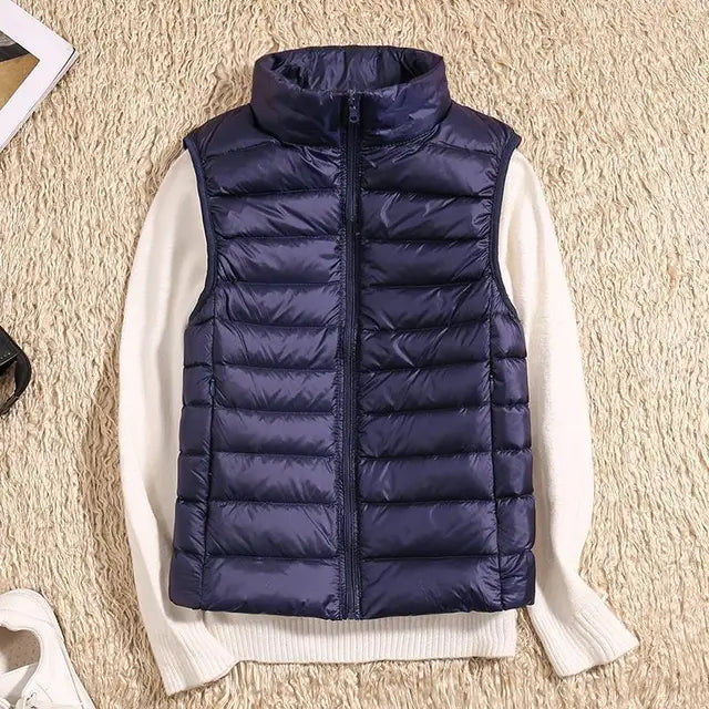 Slim-fit women's lightweight down vest, flattering & warm for any occasion. A versatile casual layering piece.