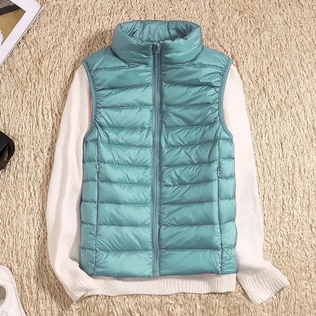 Packable women's down travel vest, lightweight & warm for adventures. A cozy, ultra-light sleeveless jacket.