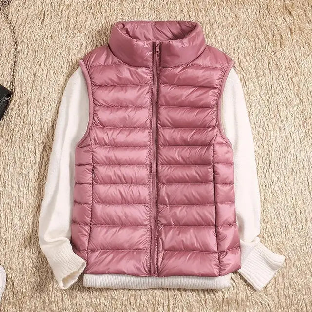 Sleek women's lightweight down vest with zipper closure. Practical, warm outerwear for fall and winter fashion.