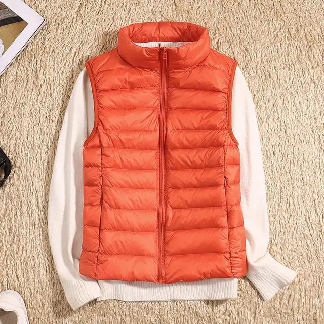Versatile women's sleeveless down vest, great for layering over sweaters or under coats. A warm, ultra-light piece.