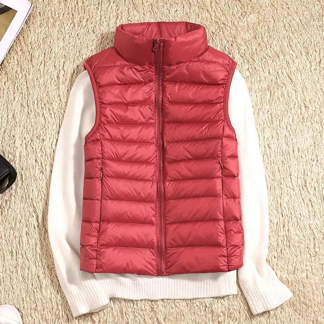 Essential women's fall/winter down vest, lightweight and provides extra warmth. A stylish, packable layering piece.