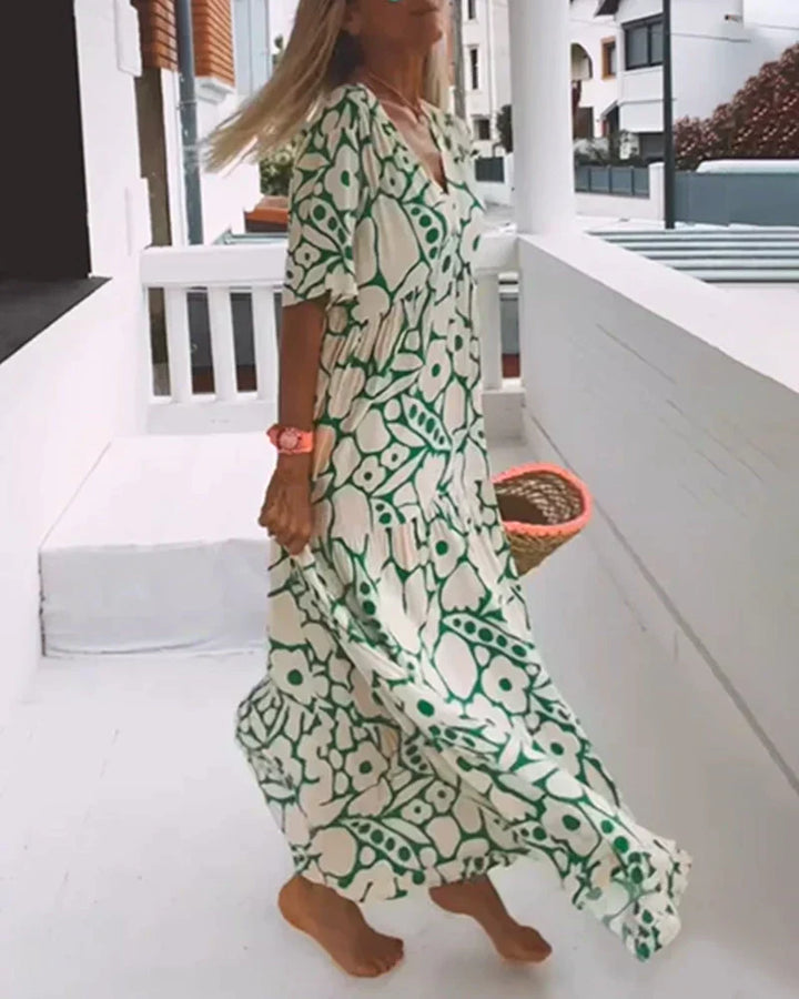 Women's elegant V-neck abstract print maxi dress with flutter sleeves, perfect for summer occasions.