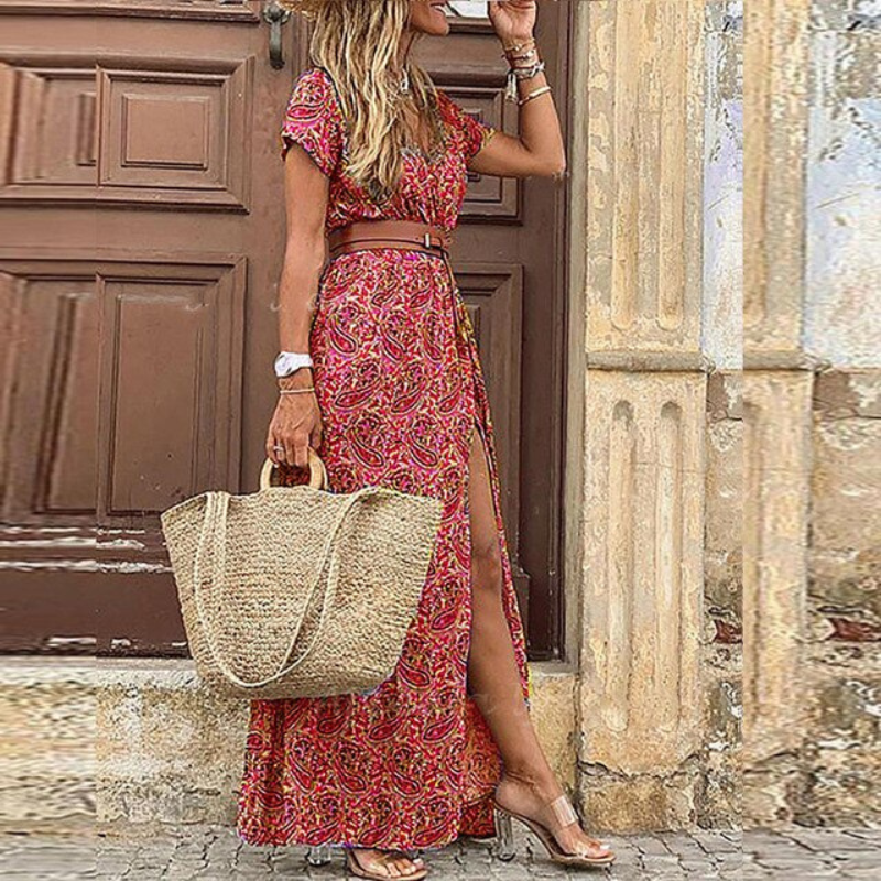 Full-length view of a belted V-neck floral maxi dress, showcasing its graceful drape and intricate pattern.