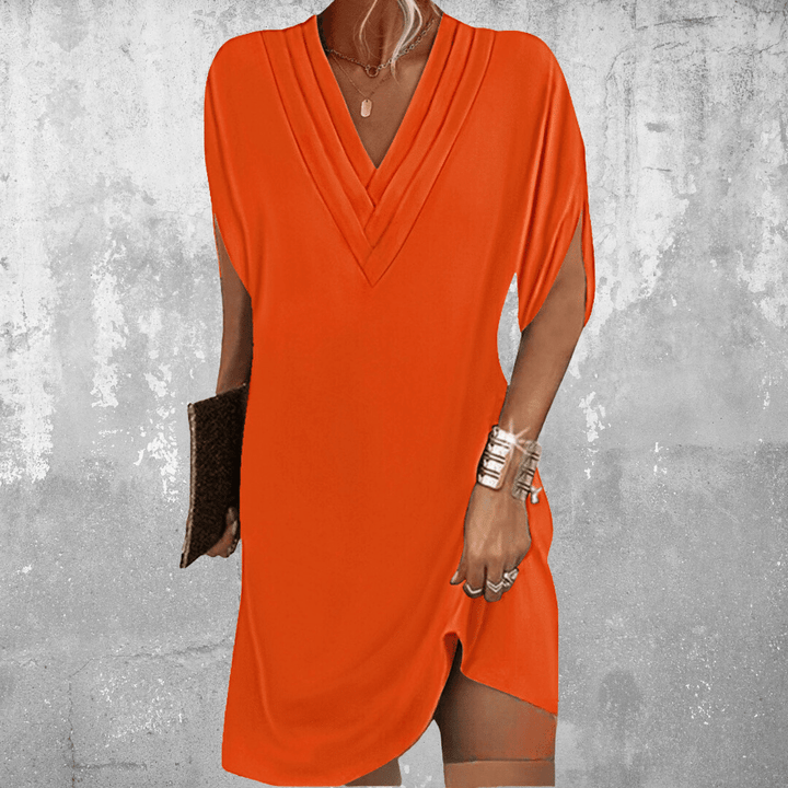 Stylish women's V-neck mini dress, relaxed fit, short summer dress, perfect for a casual warm weather look.