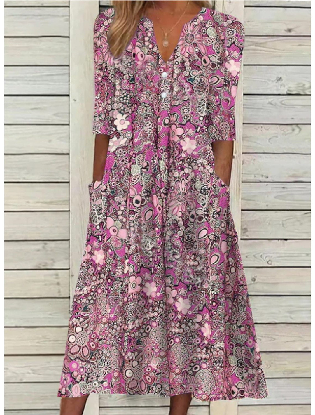 Stylish women's printed V-neck midi dress with 3/4 sleeves and pockets, ideal for casual summer fashion.