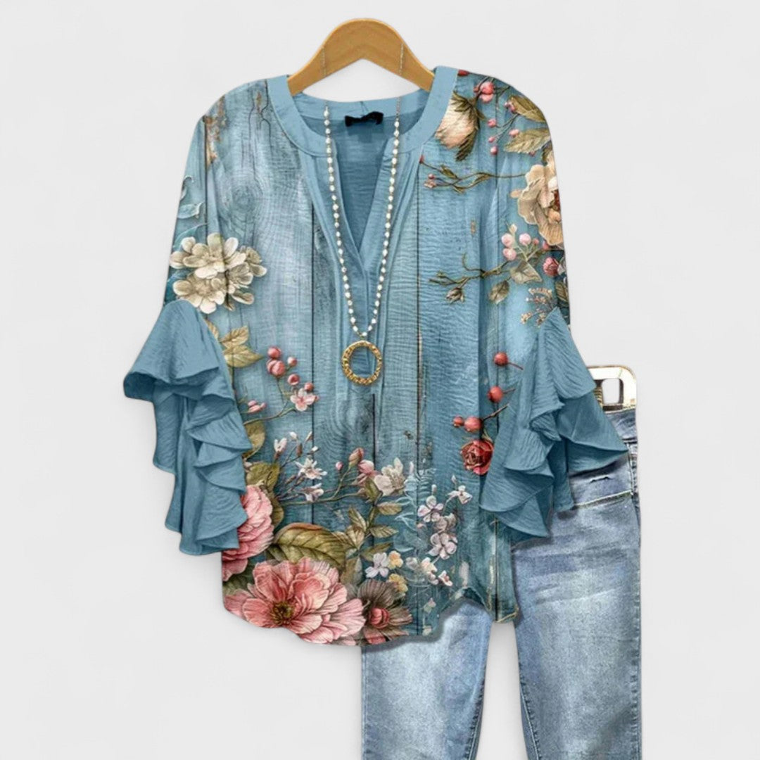 Lightweight summer V-neck blouse with ruffle sleeves, offering comfort & style. Ladies fashion.