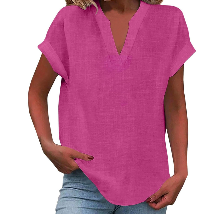 Stylish woman models a comfortable V-neck short sleeve blouse, featuring a relaxed fit for spring fashion.