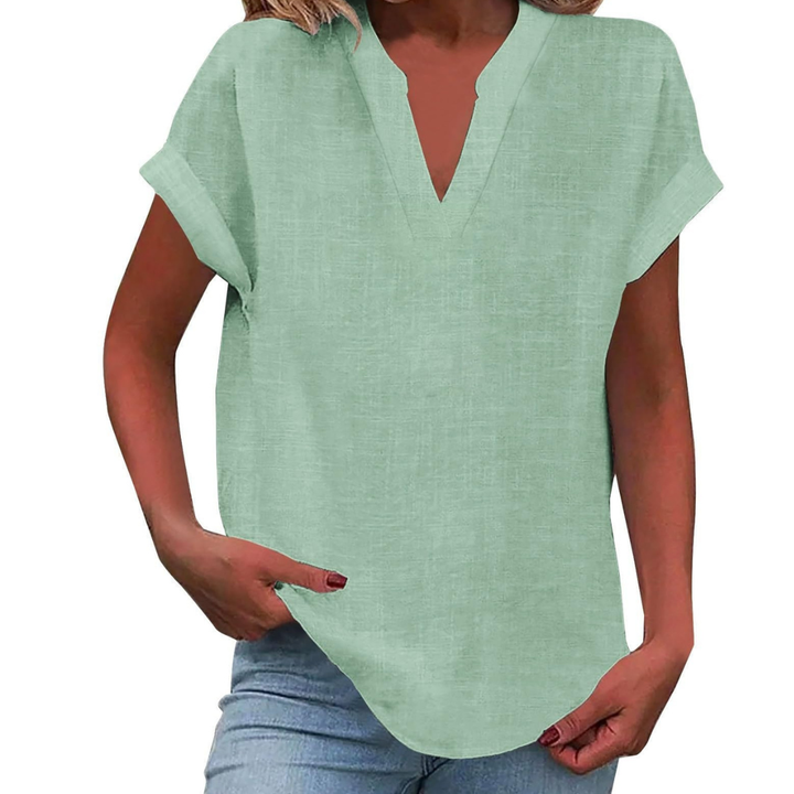 Close-up of a women's V-neck blouse, highlighting the smooth fabric and short sleeve detail for comfort.