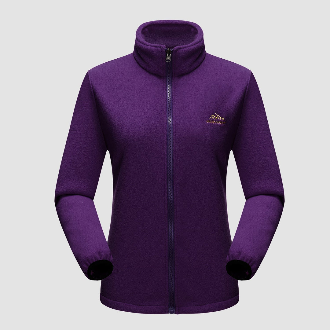Woman walking in a scenic landscape wearing a Verona 3-in-1 women's waterproof jacket, ideal for fall.