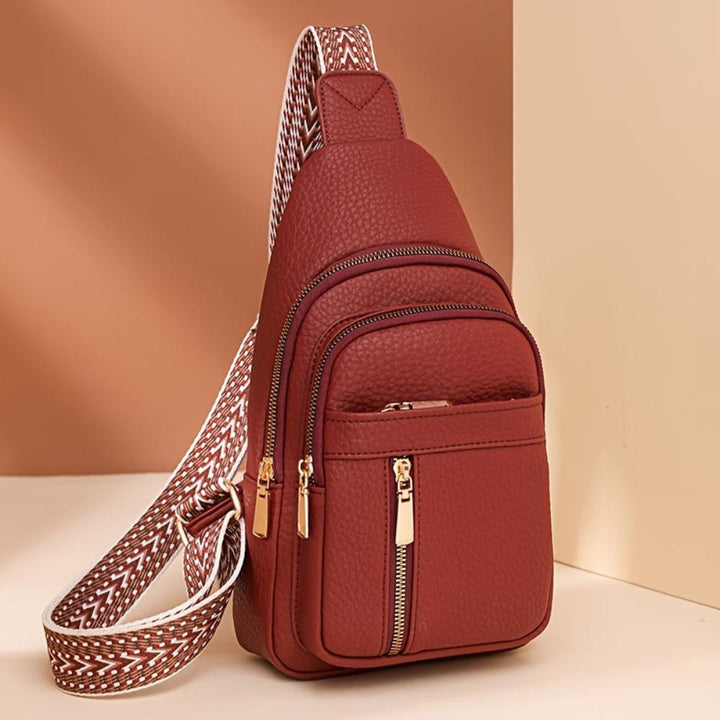 Classic front view of a women's vintage brown leather chest crossbody bag.