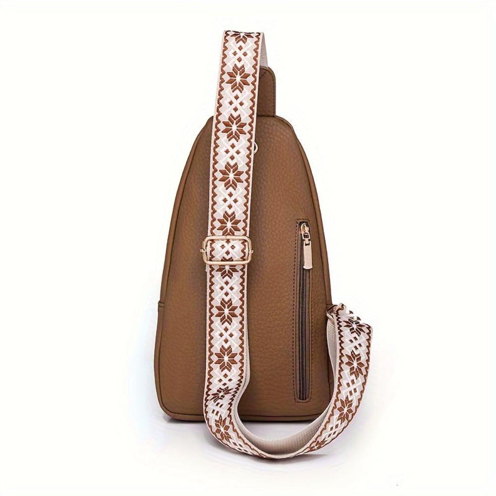 Vintage brown leather crossbody bag for women, shown carried over a casual outfit.