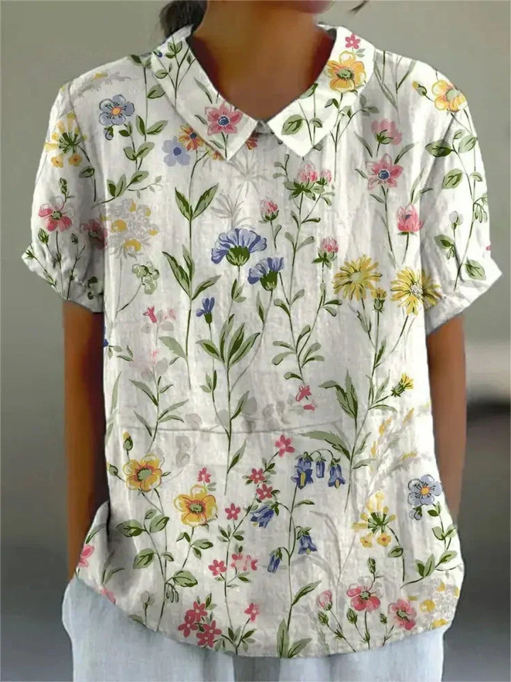 Chic women's summer blouse with delicate floral embroidery in a vintage style.