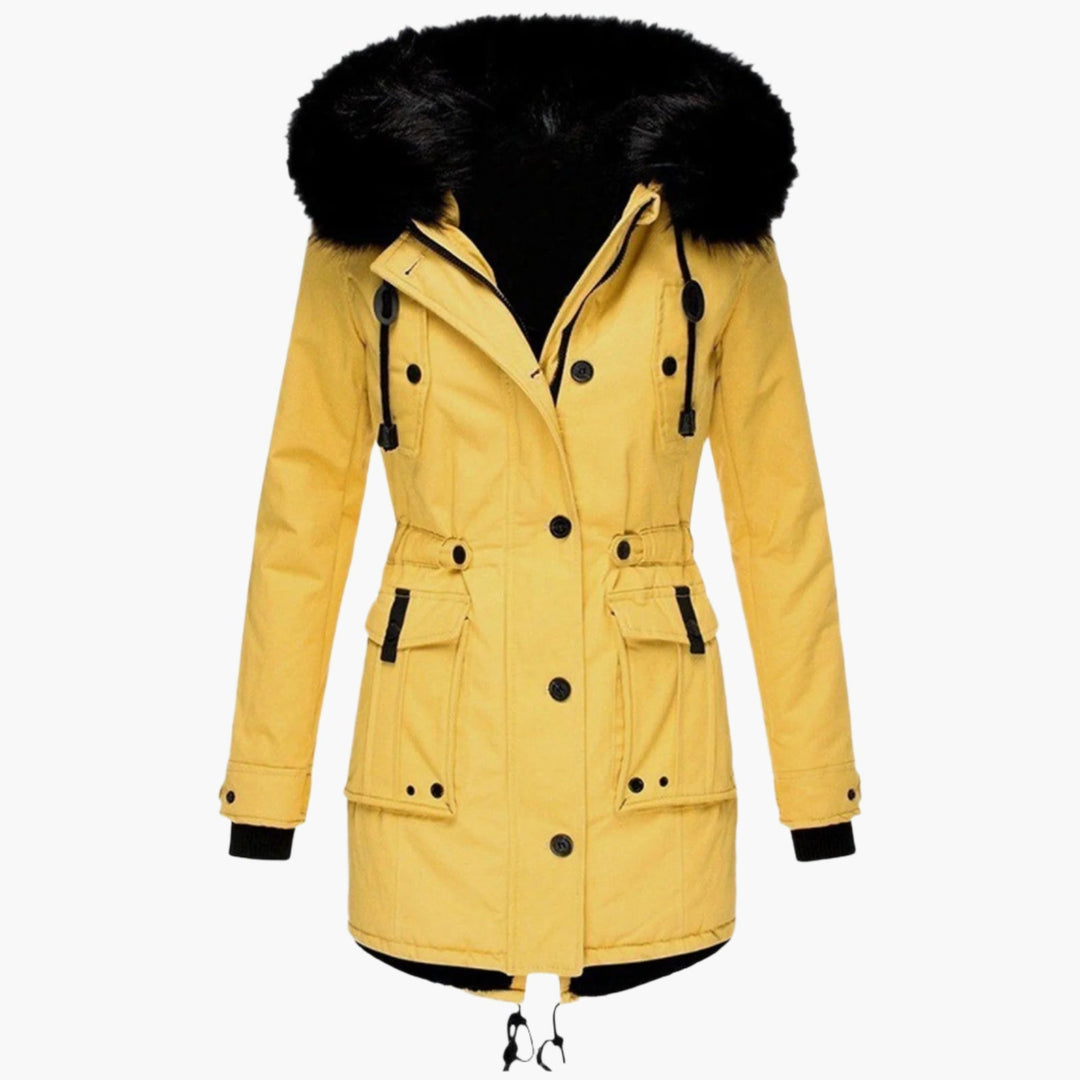 Woman smiling wearing a black warm hooded puffer winter coat outdoors in a winter setting.