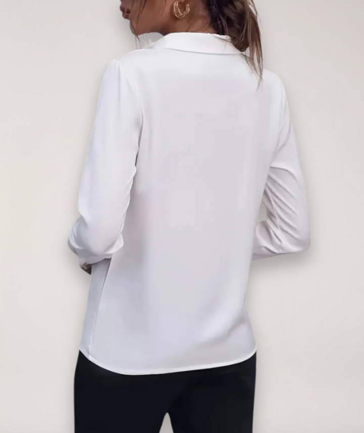 Elegant women's spring office top, a buttoned long-sleeve blouse in a light fabric.