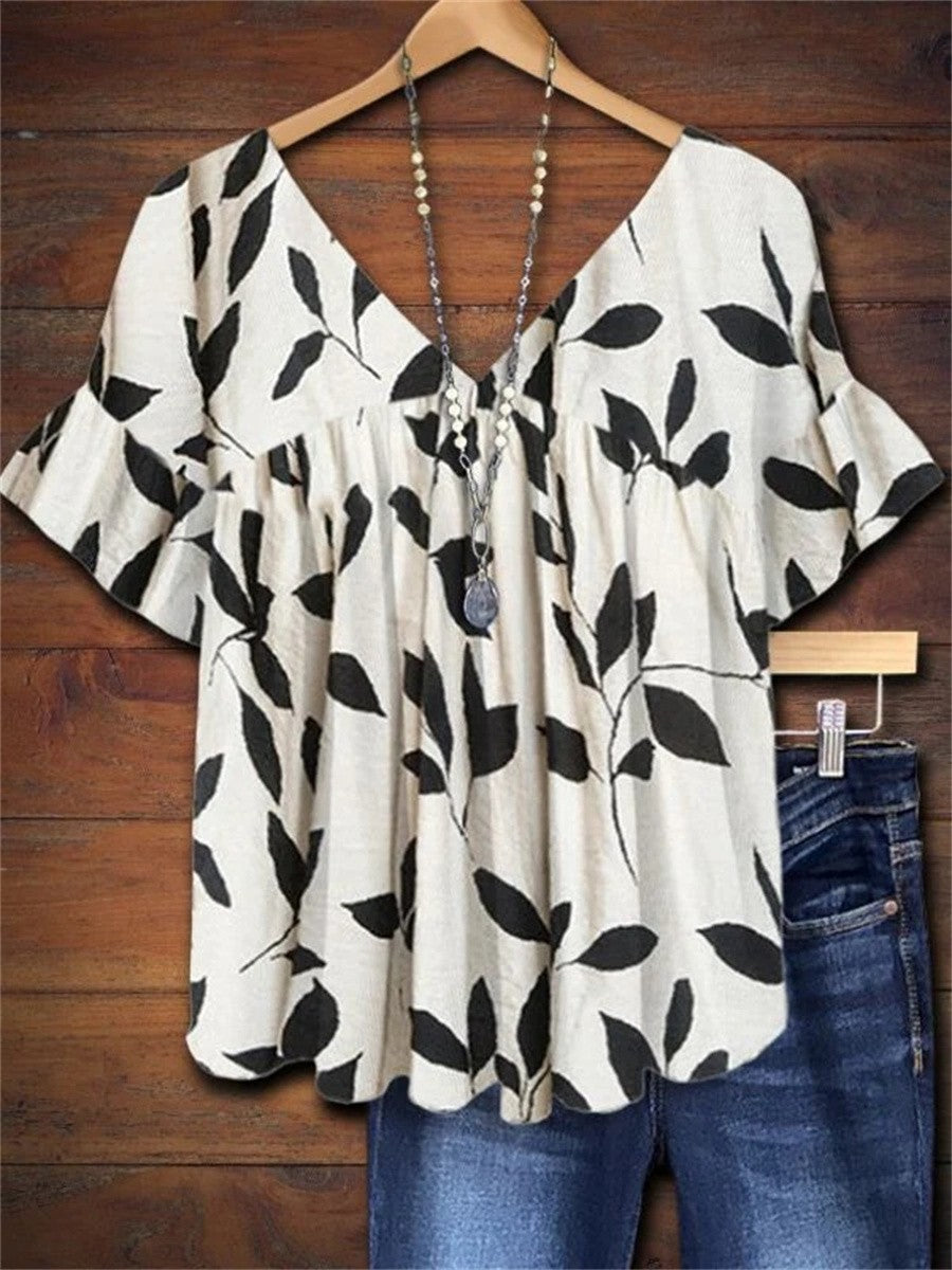 Women's white leaf print V-neck flutter sleeve blouse, a relaxed fit summer top for casual everyday wear.