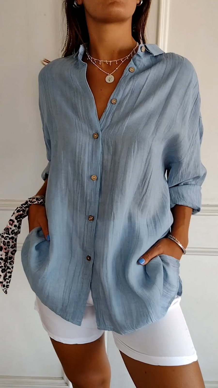 Women's white oversized button-down collared shirt. Relaxed fit, long sleeve for casual and everyday style.