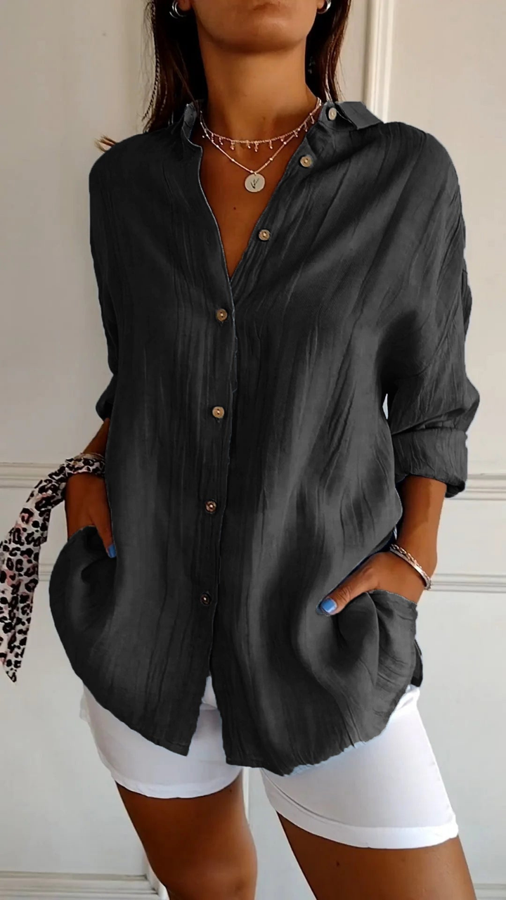 Trendy women's oversized button-down shirt in a relaxed fit. Collared, long sleeve, perfect for spring/summer fashion.