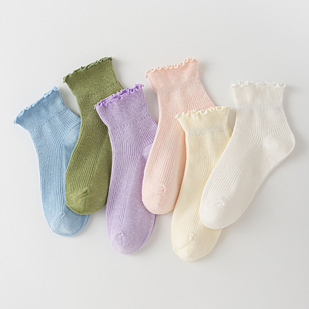 Women's white ruffle ankle socks with delicate lace trim, perfect for a cute & feminine everyday look.