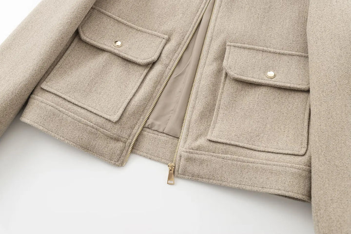 Detail shot of the sturdy zipper on a women's wool bomber jacket, functional and chic
