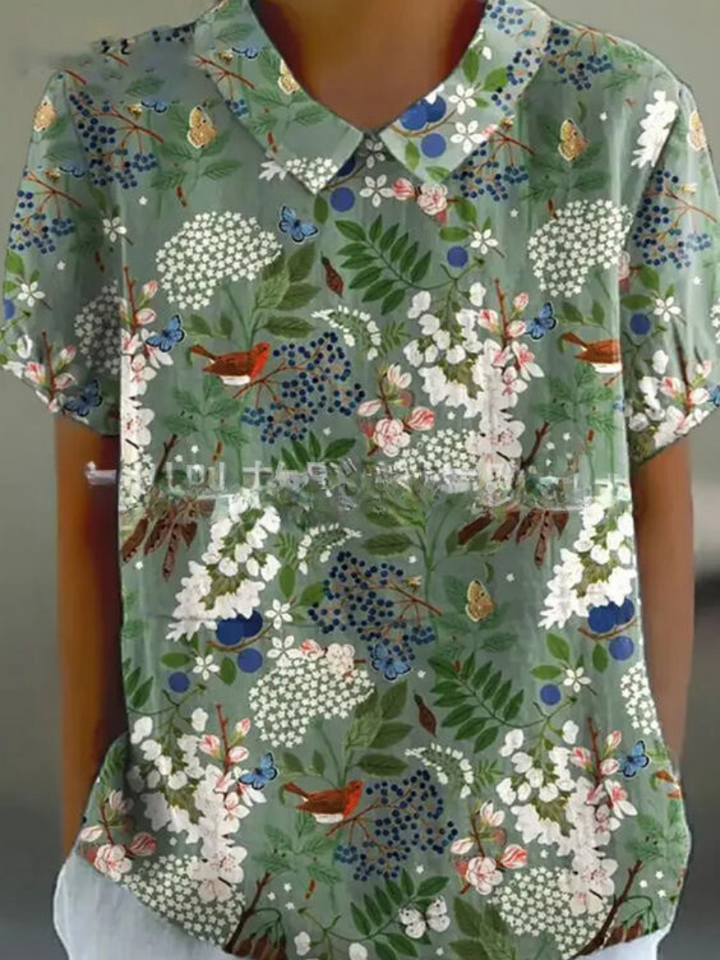 Women's blouse with short gathered sleeves, pointed collar, relaxed fit, perfect for spring-summer style and comfort.
