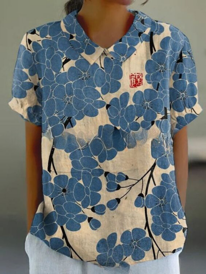 Women's blouse with short gathered sleeves, pointed collar, relaxed fit, perfect for spring-summer style and comfort.