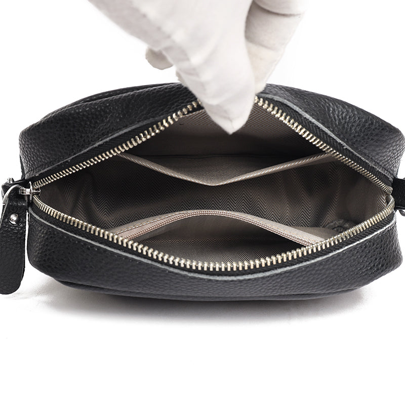 "Women's boxy camera bag with detachable chevron strap, pebbled texture, rectangular shape, and secure zip closure."