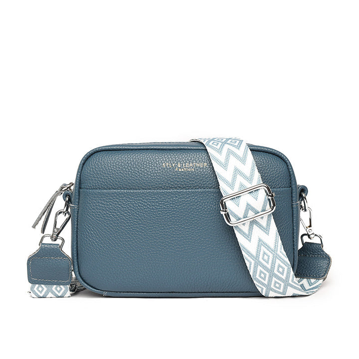 "Women's boxy camera bag with detachable chevron strap, pebbled texture, rectangular shape, and secure zip closure."