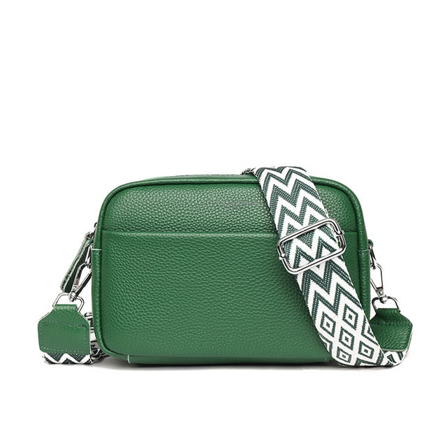 "Women's boxy camera bag with detachable chevron strap, pebbled texture, rectangular shape, and secure zip closure."