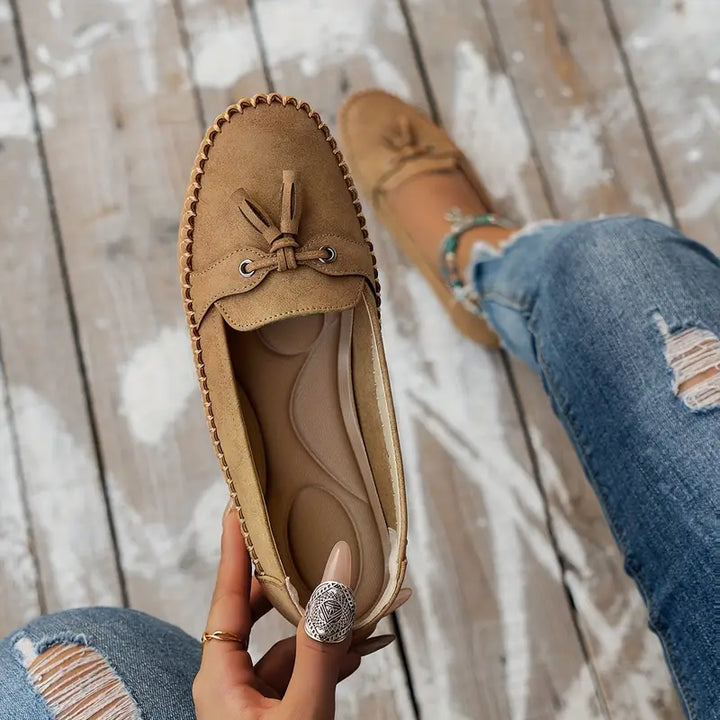 "Women's classic bow loafers in soft suede, stylish flat slip-ons with elegant bow accent, ideal for any occasion."