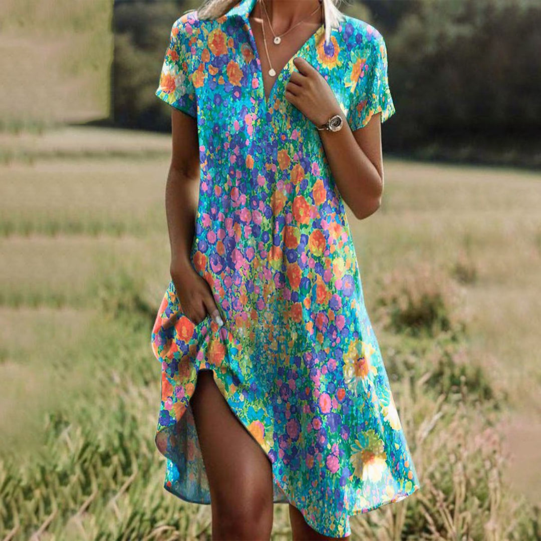 Women's floral midi summer dress with V-neckline, bold pattern, front slit, relaxed fit, perfect for sunny days.