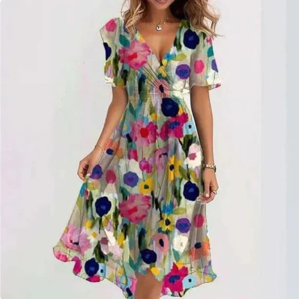 Women's floral wrap midi dress with flutter sleeves, V-neckline, asymmetrical hem, and soft floral print design.