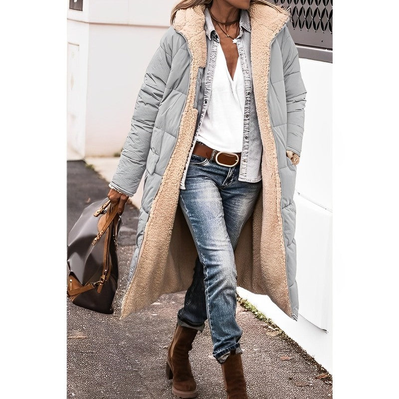 "Women's hooded longline quilted winter coat, front view; insulated, open front design with quilted texture and hood."
