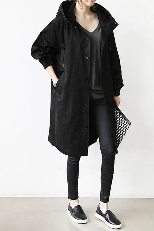 Women's hooded waterproof trench coat, front view. Adjustable hood, belted waist, available in various colors.