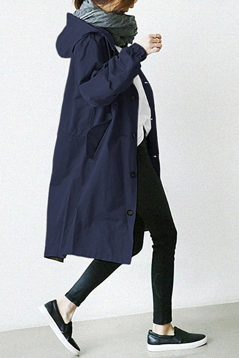 Women's hooded waterproof trench coat, front view. Adjustable hood, belted waist, available in various colors.