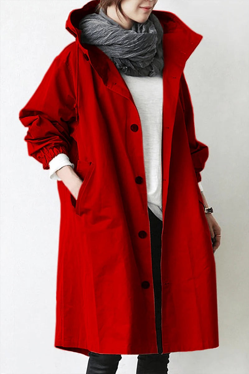 Women's hooded waterproof trench coat, front view. Adjustable hood, belted waist, available in various colors.
