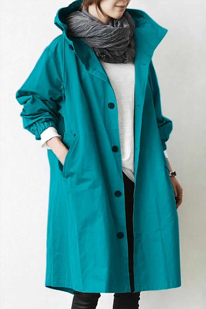 Women's hooded waterproof trench coat, front view. Adjustable hood, belted waist, available in various colors.