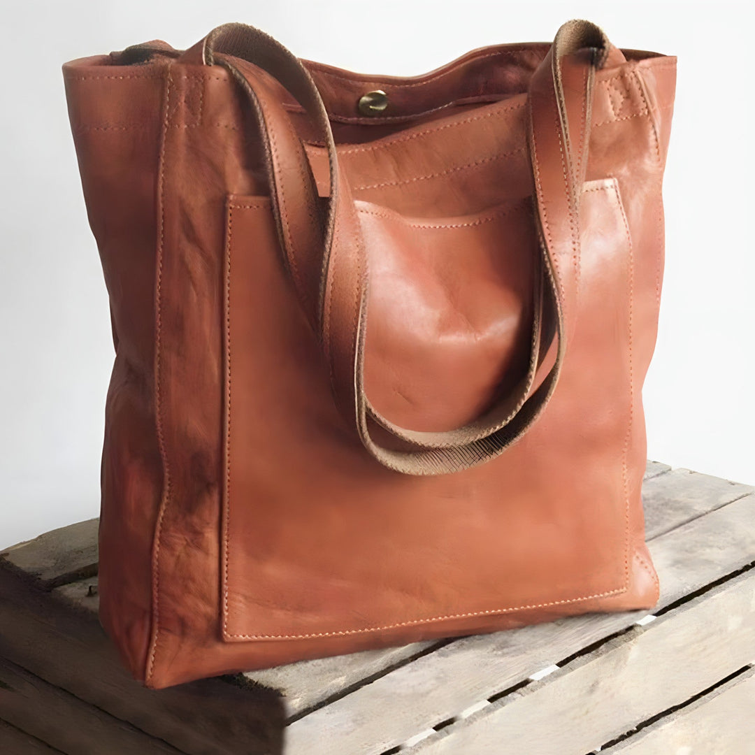 "Women's oversized leather-style shoulder tote bag with spacious interior, long straps, and elegant design."