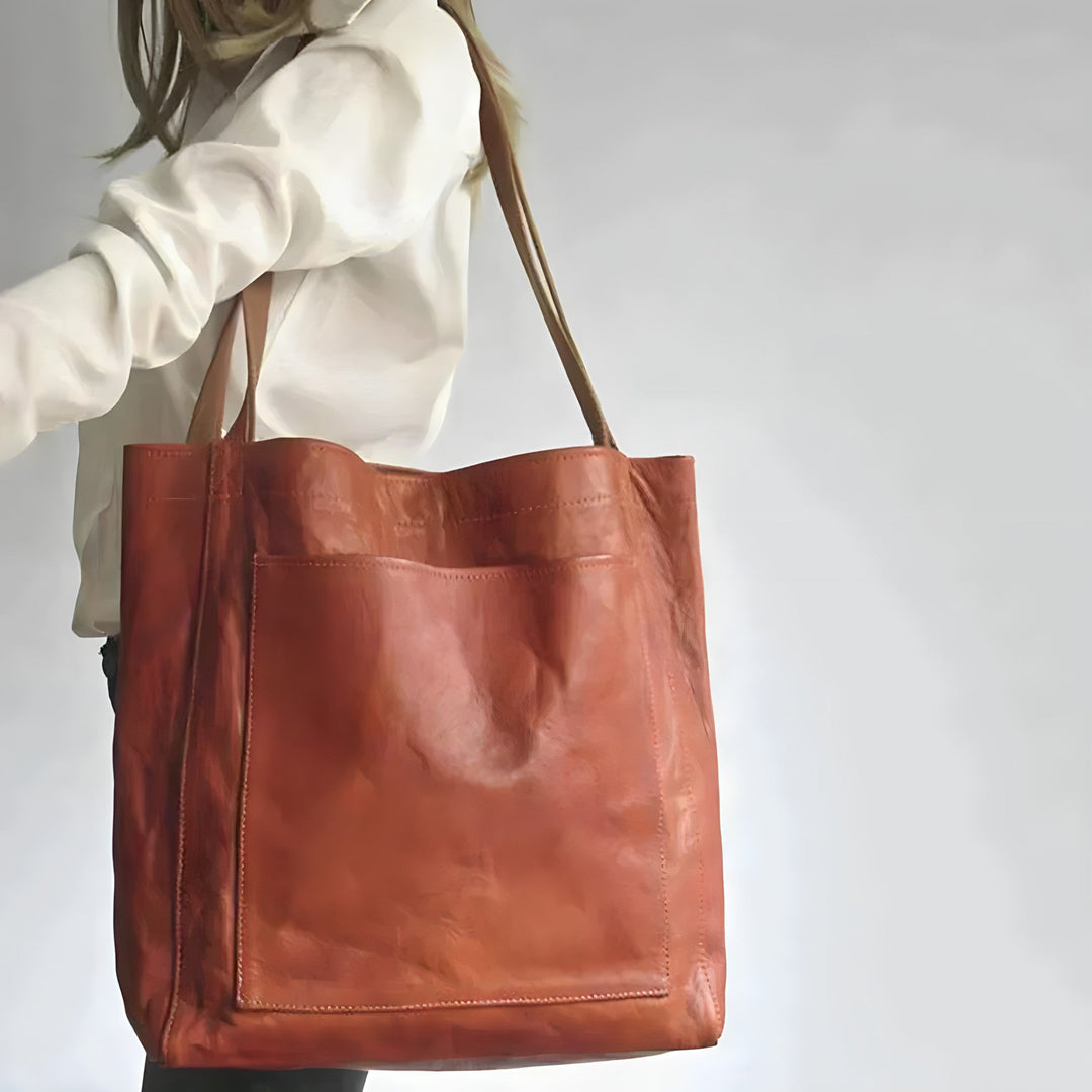 "Women's oversized leather-style shoulder tote bag with spacious interior, long straps, and elegant design."