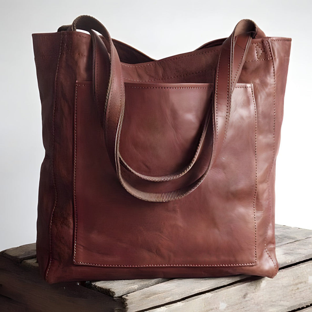 "Women's oversized leather-style shoulder tote bag with spacious interior, long straps, and elegant design."