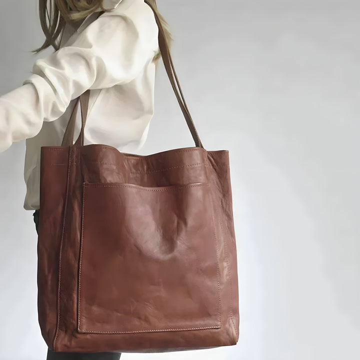 "Women's oversized leather-style shoulder tote bag with spacious interior, long straps, and elegant design."
