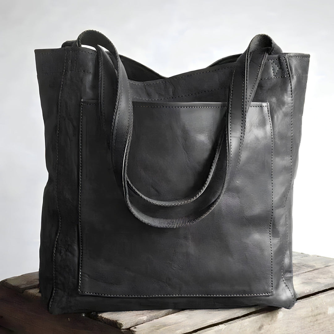 "Women's oversized leather-style shoulder tote bag with spacious interior, long straps, and elegant design."
