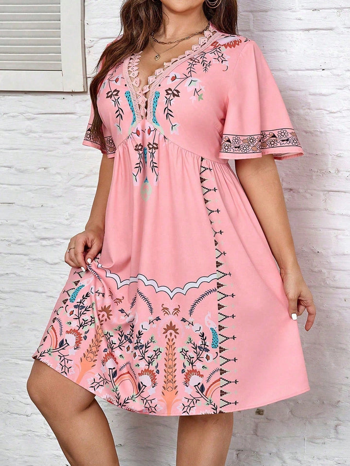 Women's plus size midi dress with boho lace, featuring intricate details and flowing silhouette, front view.