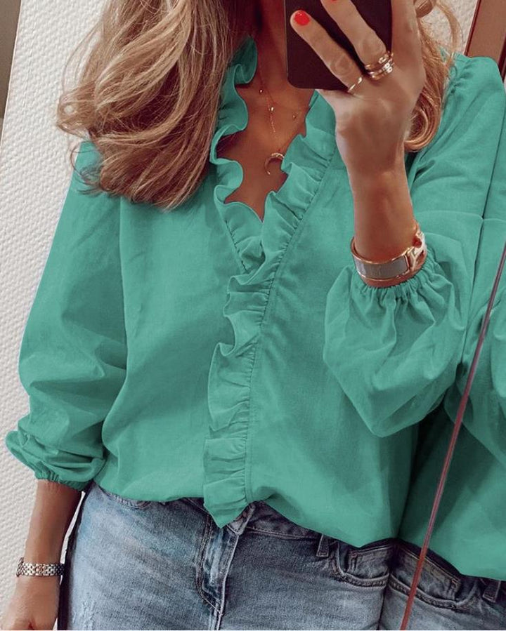 "Women's ruffled V-neck blouse, elegant ruffles, flattering silhouette, chic and feminine style, perfect for versatile occasi