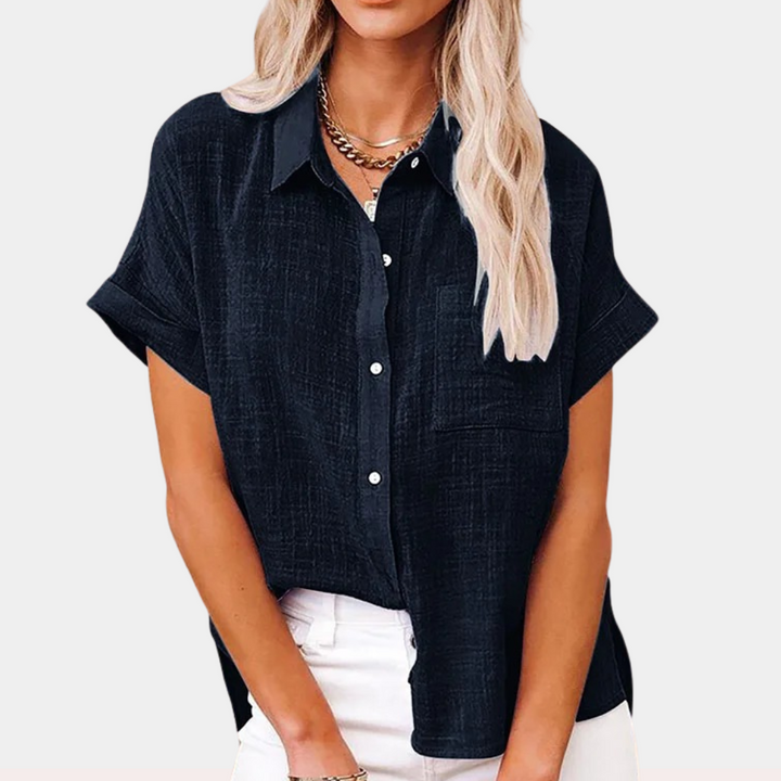 "Women's summer blouse with button-down front and classic collar, relaxed fit in light blue, front view."