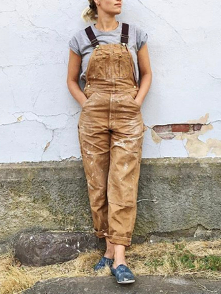 Women's utility bib overalls, adjustable straps, multi-patch pockets, wide-leg fit, durable, stylish canvas workwear.