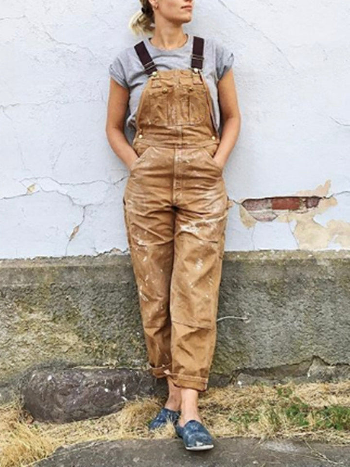 Women's utility bib overalls, adjustable straps, multi-patch pockets, wide-leg fit, durable, stylish canvas workwear.