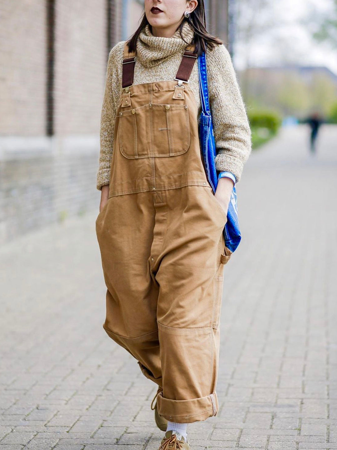 Women's utility bib overalls, adjustable straps, multi-patch pockets, wide-leg fit, durable, stylish canvas workwear.