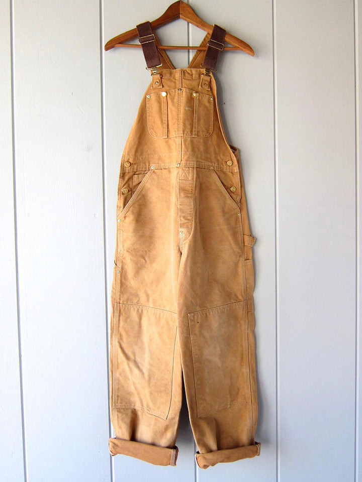 Women's utility bib overalls, adjustable straps, multi-patch pockets, wide-leg fit, durable, stylish canvas workwear.