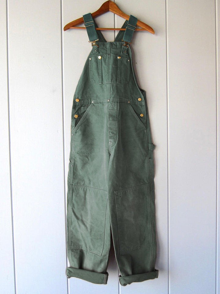 Women's utility bib overalls, adjustable straps, multi-patch pockets, wide-leg fit, durable, stylish canvas workwear.